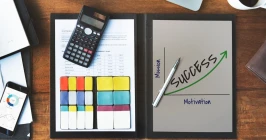 Checklist and pay stubs on desk prepared for tax season with calculator and notes