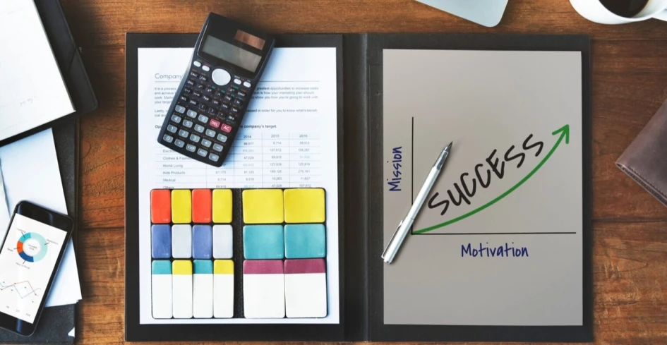 Checklist and pay stubs on desk prepared for tax season with calculator and notes